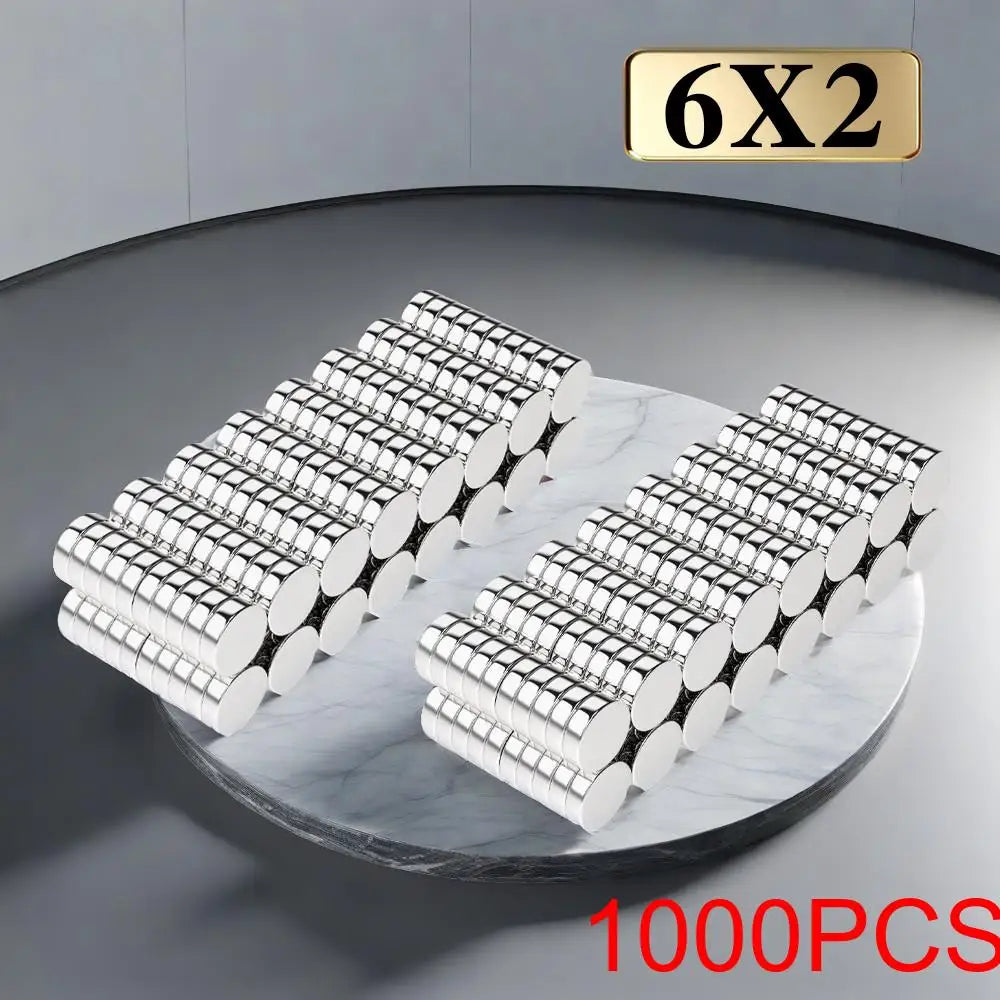 A set of 6x2 precision refrigerator magnets in silver and white are displayed on a marble surface.