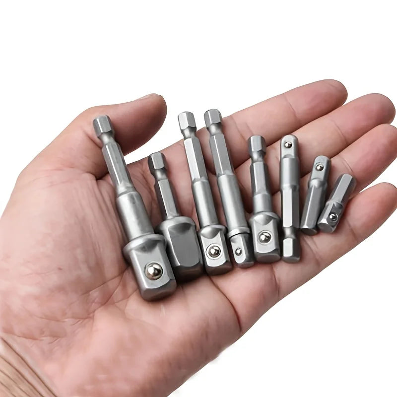 A hand holds a set of multi-sized drill socket adapters for impact drivers.