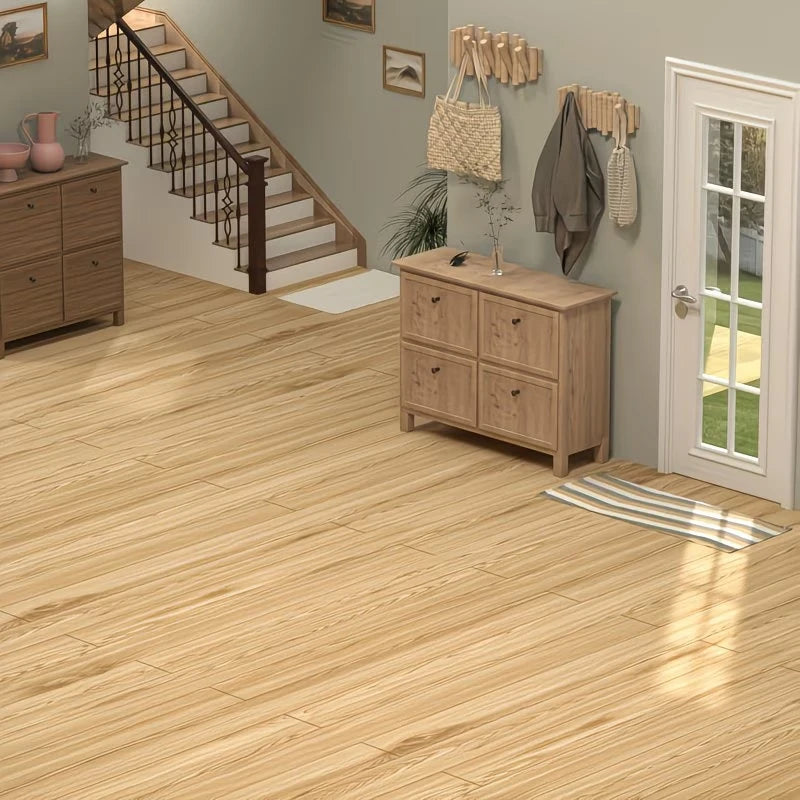 A light wood grain floor is shown in a room with a staircase, storage cabinets, and wall decor.