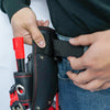 A hand is shown opening a black utility tool pouch with a red belt clip attached to it.