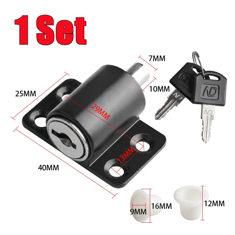 A set of black sliding door window locks and hardware, including a main lock and two small white components.