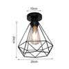 Black geometric wire frame chandelier lamp with an exposed filament light bulb