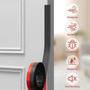 Black and red door draft stopper seal strips installed on a white door frame.