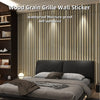 A bedroom wall decorated with vertical wood grain stickers, featuring a bed and dark wood shelving.