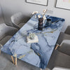 A marble self-adhesive PVC wallpaper is displayed on a dining table with gray chairs and decorative elements.
