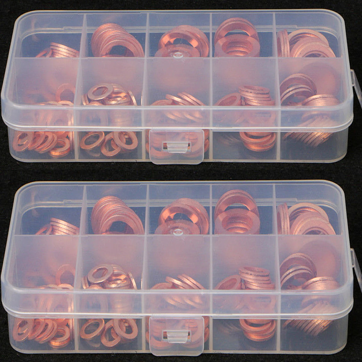 A clear plastic container holds a set of copper gaskets and washers.