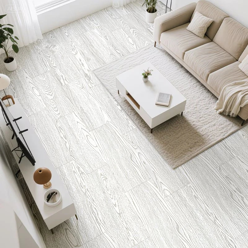 A bright, modern living room featuring light wood grain peel and stick floor tiles, a beige sofa, and a white coffee table.