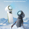 A handheld cooling fan with a digital display and control settings is shown against a snowy mountain background.