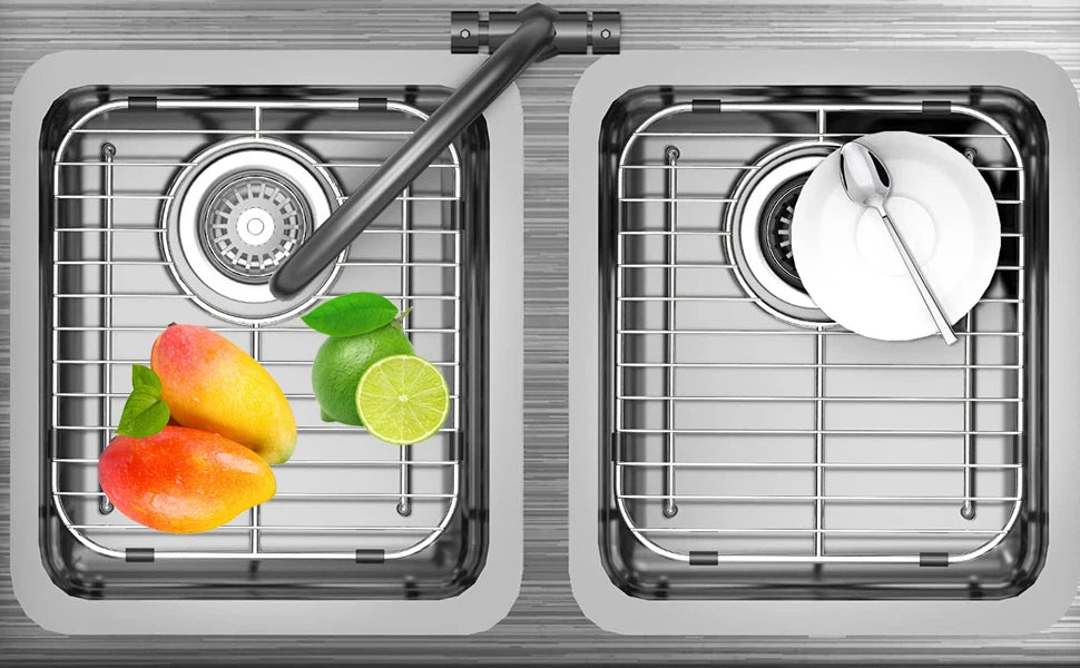 Two stainless steel sink protector grids show fresh fruit and a plate with silverware.