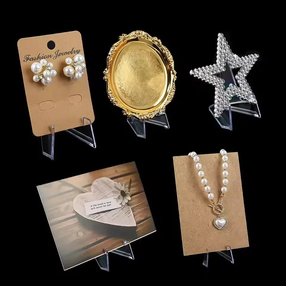 A collection of gold and silver jewelry displayed on acrylic stands.