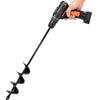A hand is holding a black garden auger drill bit with an orange handle, showing the spiral tip.