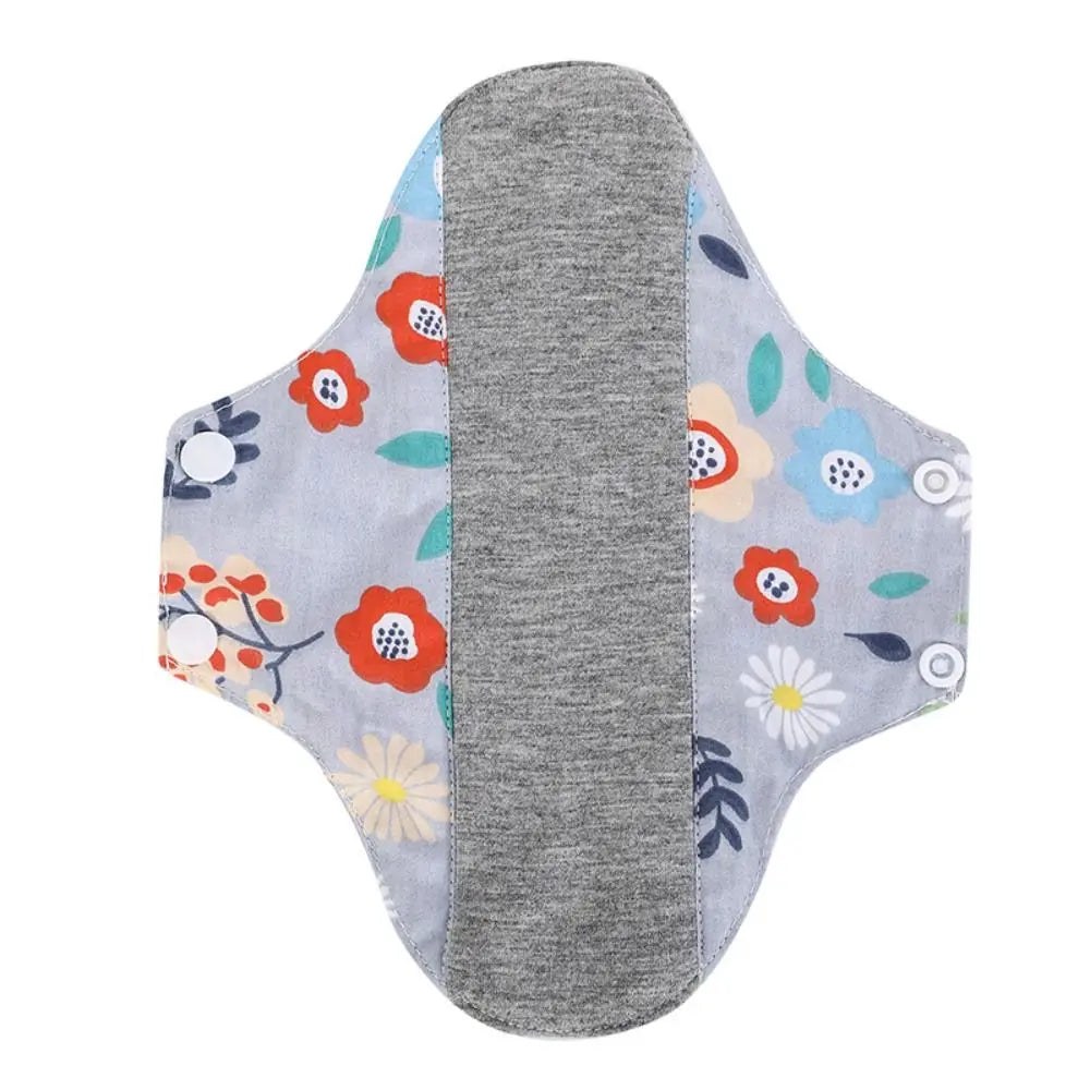 Reusable absorbent sanitary cloth pads featuring a gray pad with floral patterns on the sides