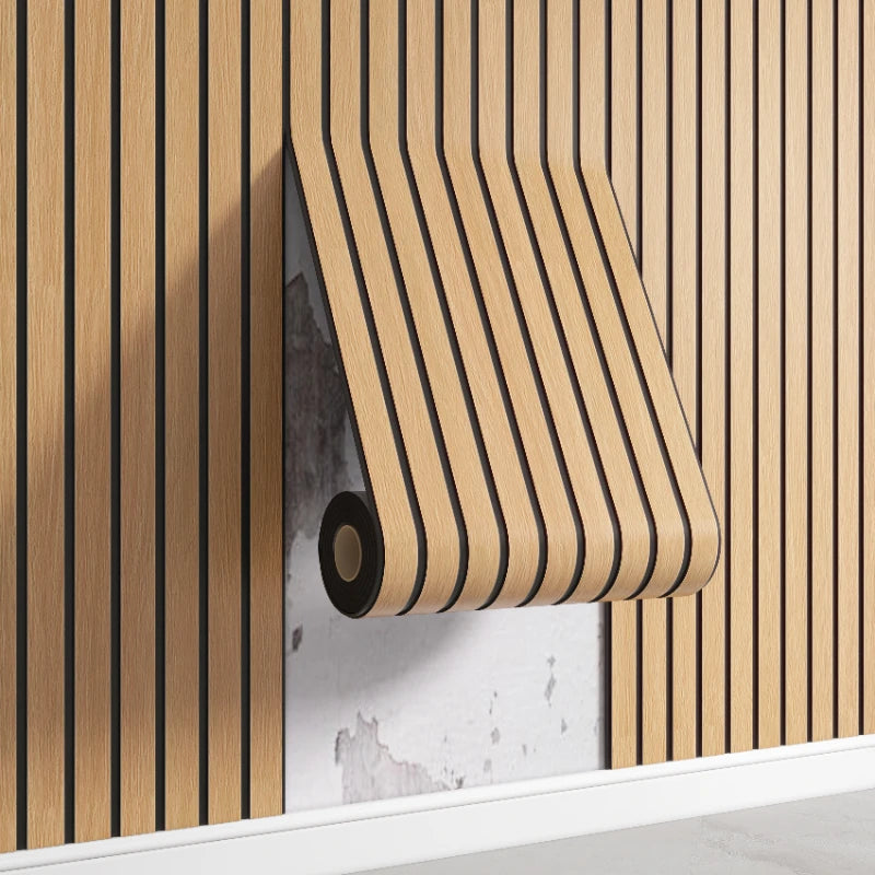 A roll of wood-grain wall decal sticker is mounted on a light shelf against a vertical wooden slat background.