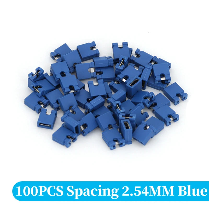 A pile of 100 blue spacing jumper cap connectors with a 2.54mm pitch.