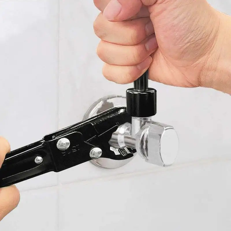A hand is operating a black professional double-ended pipe wrench set on a white surface.
