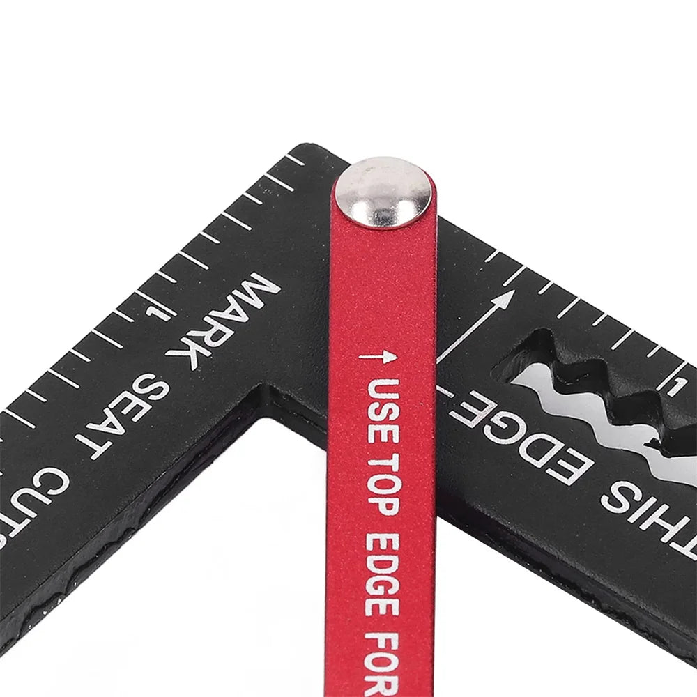 A close-up view of a precision aluminum angle measuring ruler with a red body and silver tip.