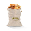 A beige linen drawstring bag filled with assorted baked goods like croissants and rolls.