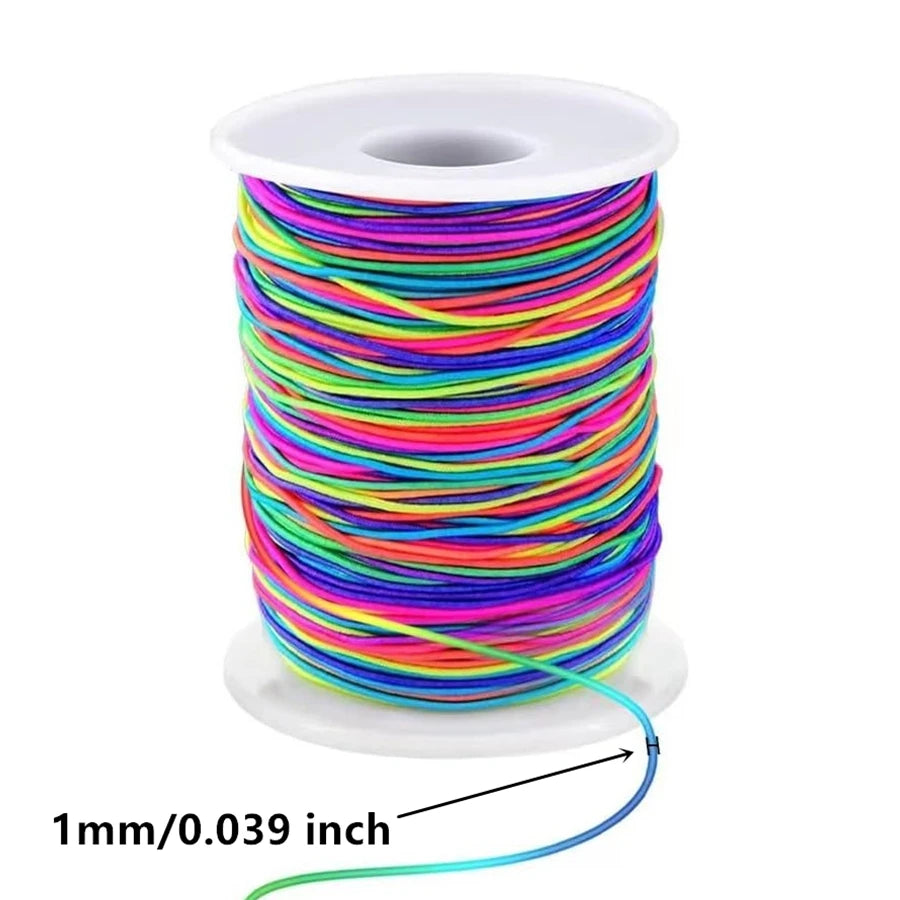 A spool of 1mm stretchy rainbow elastic cord for jewelry making, coiled on a white disk.