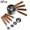 An 8 piece stainless steel and wooden measuring spoon set with various sizes