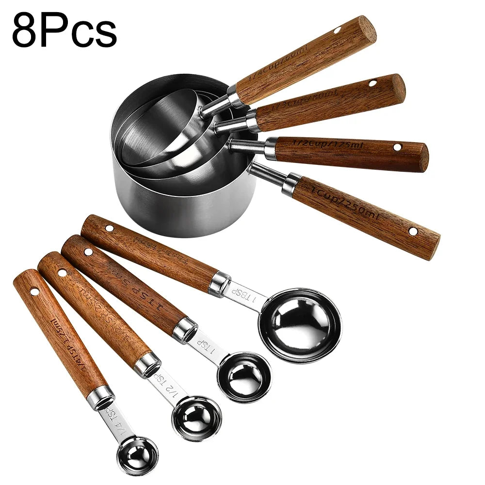 An 8 piece stainless steel and wooden measuring spoon set with various sizes