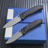 A set of carbon fiber folding knives displayed on a blue box.
