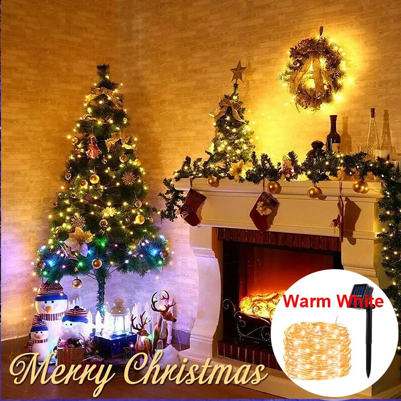 A festive Christmas scene featuring a decorated tree and fireplace with warm white fairy lights.