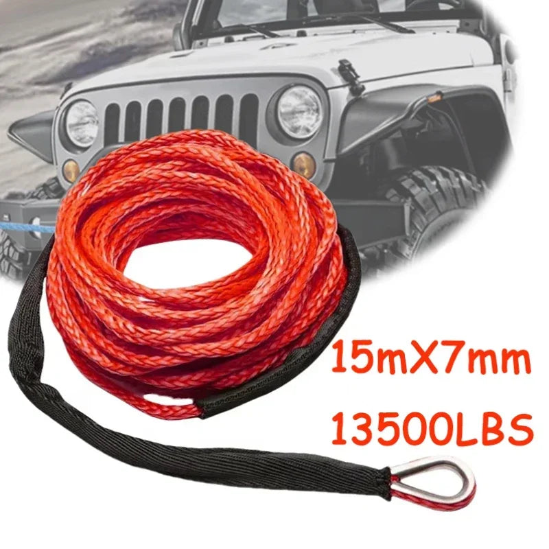 A coil of red synthetic tow strap with a black handle is shown against a background of a Jeep.
