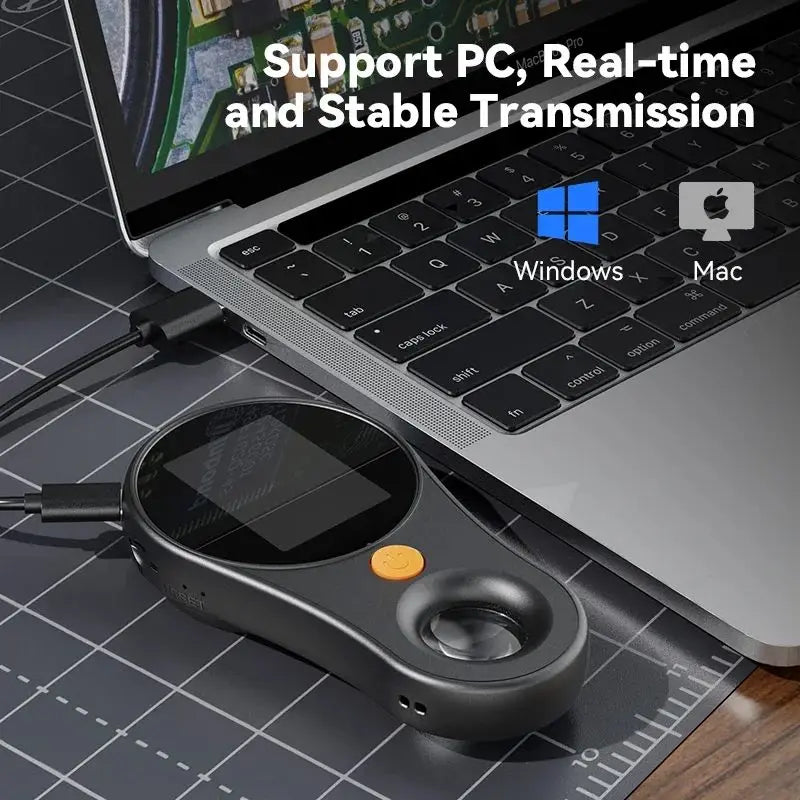 A digital handheld microscope with an LED light is placed on a laptop keyboard.