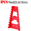 Red plastic wrench organizer rack with serrated edges and slots