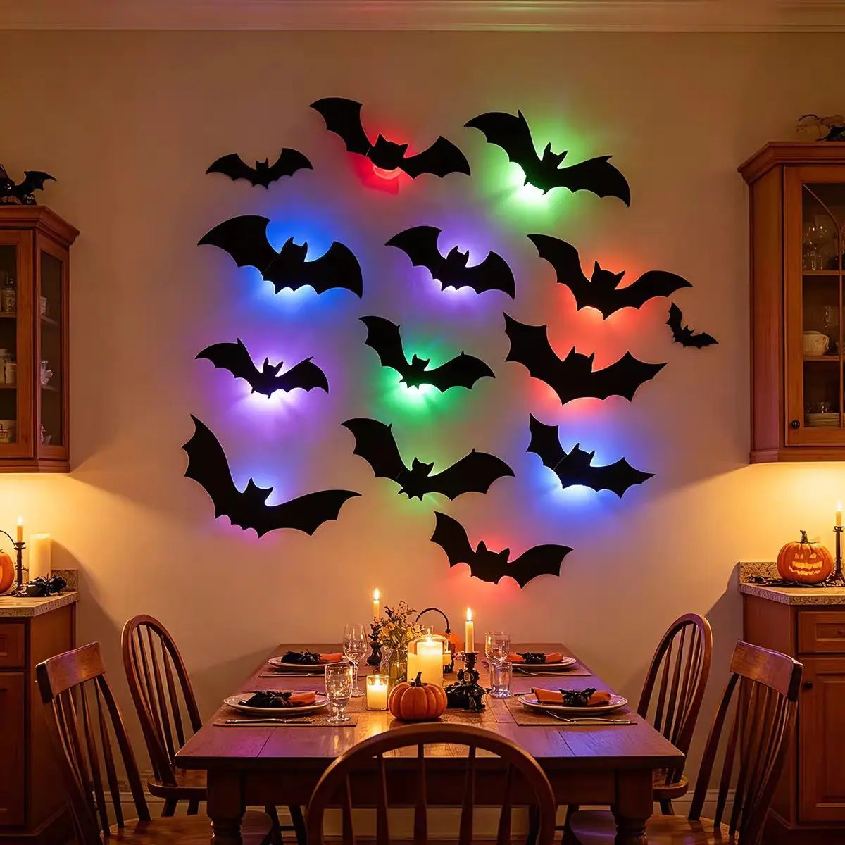 Wanddekoration mit schwarzen und grünen LED-Fledermaus-Silhouetten an einer hellen Wand.