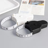 A white portable telescopic health tape measure with a black torch is shown next to a white tape and some printed paper.