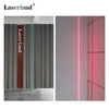 A vertical laser module with a red light beam is displayed against a gray wall.