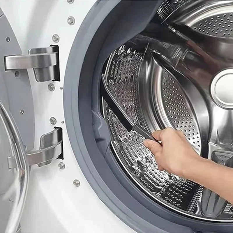 A hand is using a cleaning brush to clean the interior of a dishwasher basket.