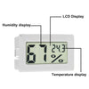 A white digital LCD display showing humidity and temperature readings on an indoor/outdoor thermometer and hygrometer.