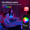 A woman and a man relax on a couch in a warmly lit room while interacting with a smartphone displaying a color spectrum.