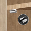 A close-up view of a silver cabinet partition support screw and a white threaded insert on a wooden cabinet panel.