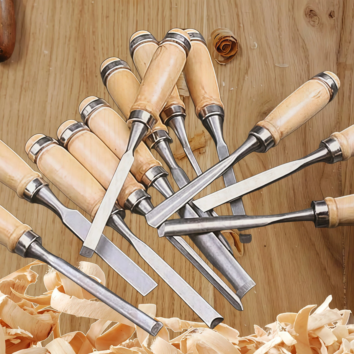 A set of twelve wooden carving chisels with metal blades arranged on a wooden surface.