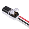 A black pluggable wire connector with clear insulation and red and black wires attached.