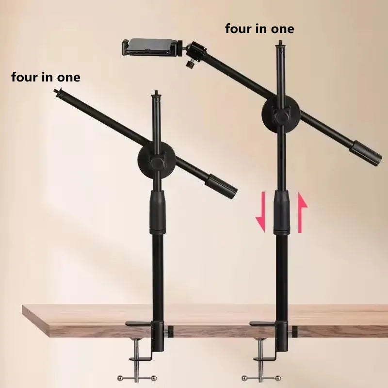 A black versatile overhead tripod featuring a ring light and boom arm mounted on a wooden surface.