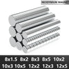 A collection of silver neodymium magnets in various sizes and thicknesses arranged in rows.