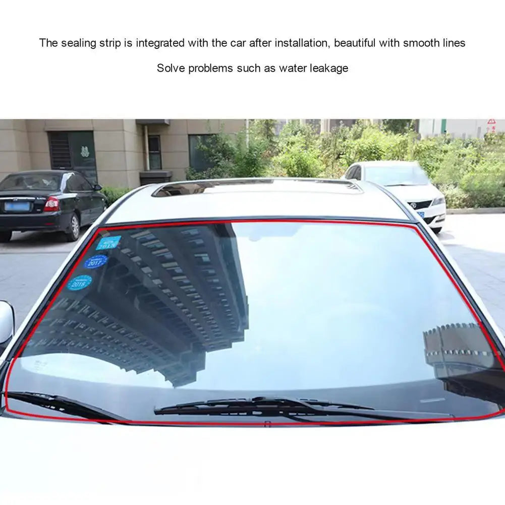 Close-up view of a car window rubber sealing strip installed on a vehicle windshield.