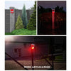 A solar motion security alarm device mounted on a pole, showing its red light illumination in various outdoor settings.