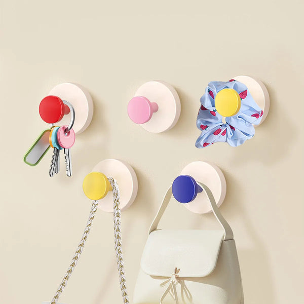 A collection of colorful reusable suction cup hooks for kitchen and bathroom use displayed against a light background.