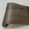 A close-up view of a brown wood grain self-adhesive wall decal roll.
