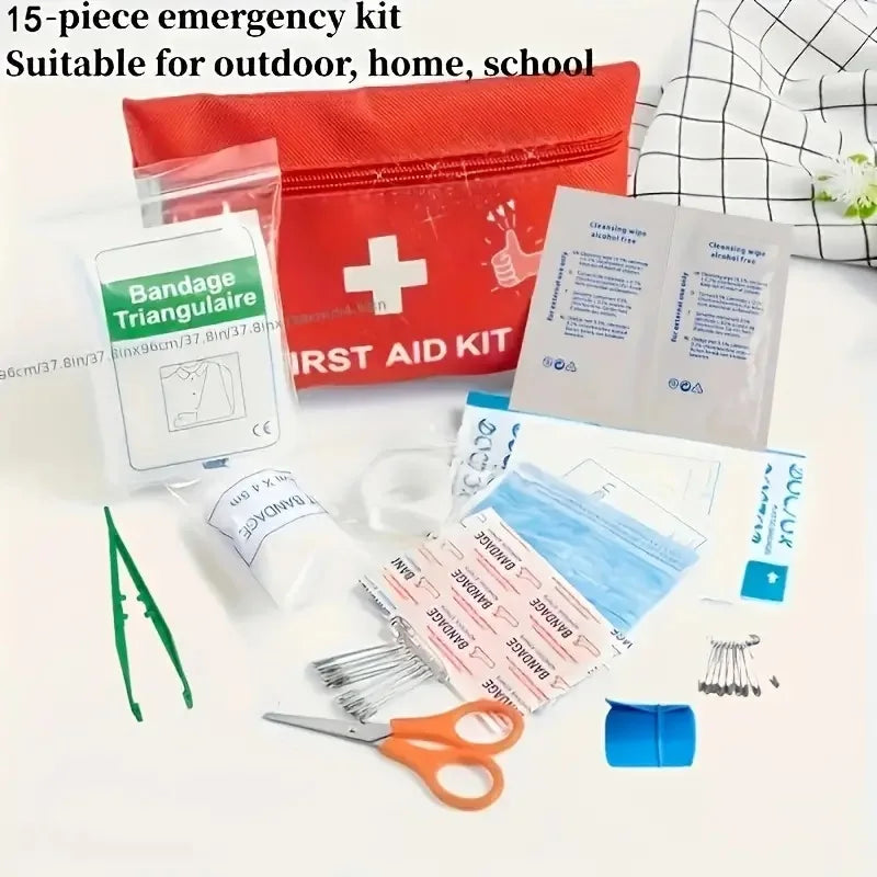 A red first aid kit containing bandages, scissors, and medical supplies is displayed on a white surface.