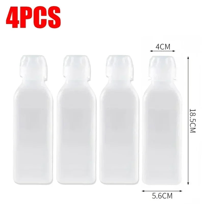 Four clear squeeze dispenser bottles with black caps and measuring lines shown side by side.