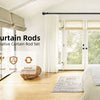 Matte black heavy duty curtain rods and decorative rod set installed in a bright room with large glass doors