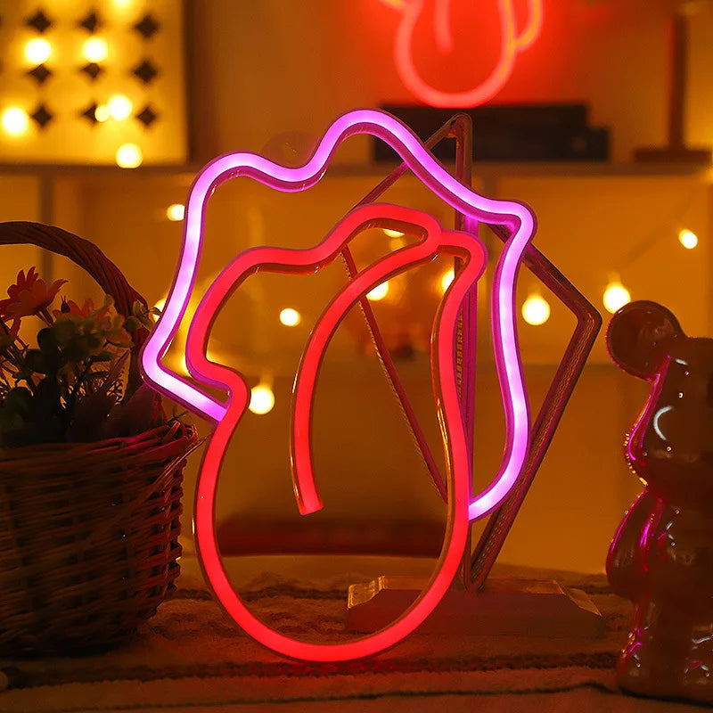A neon heart-shaped lip light decoration glows pink on a wooden surface.