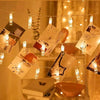 String lights with small glass bulbs are draped across a blurred background, creating a warm, festive glow.
