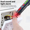 A hand is using a digital non-contact voltage tester pen to measure voltage on an electrical outlet.